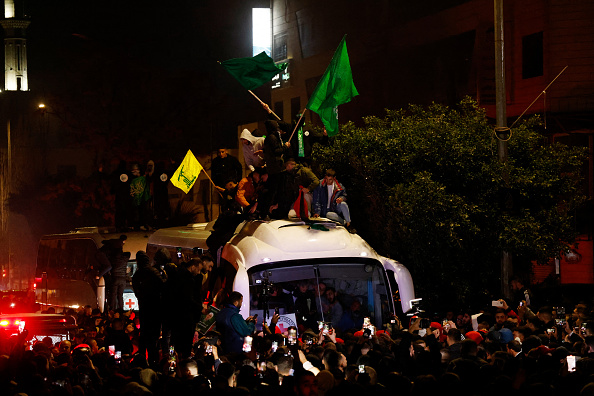Crowds cheer as freed Palestinian prisoners arrive in West Bank town