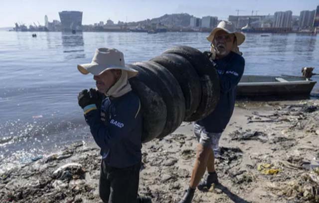 Fishermen, sailing champions clean up trash-covered Rio island