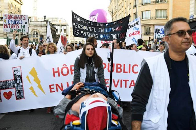 French hospital staff, relatives sue ministers over work-related suicides