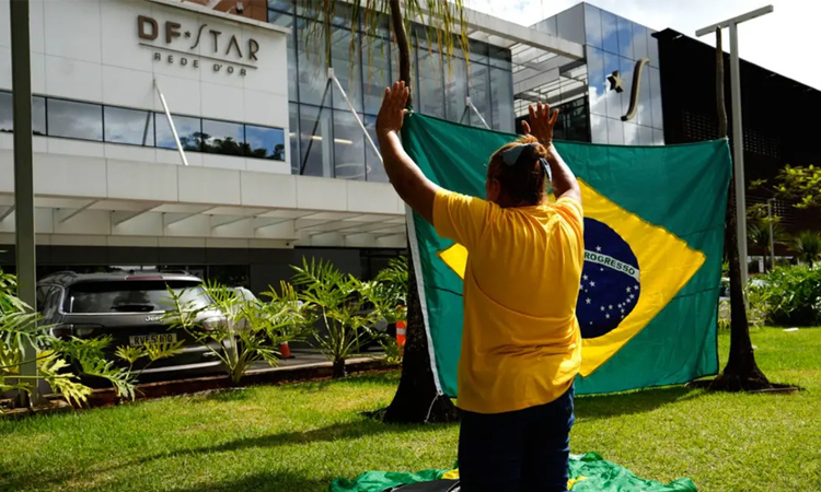 Brazil's Bolsonaro receives summons in hospital bed