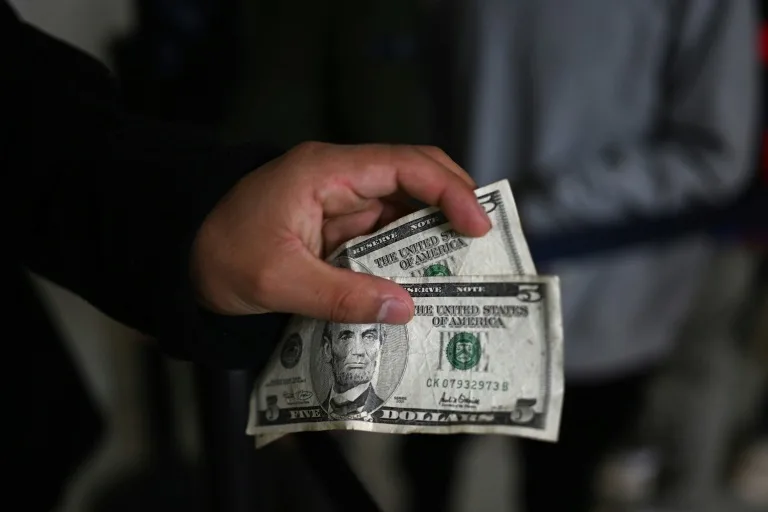 Stocks, dollar drop after US loses last triple-A credit rating