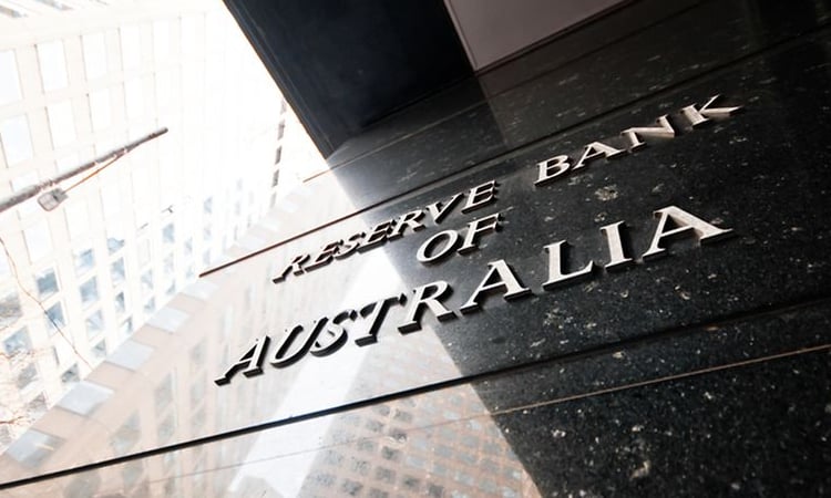 Australian central bank cuts key rate but warns of global disquiet