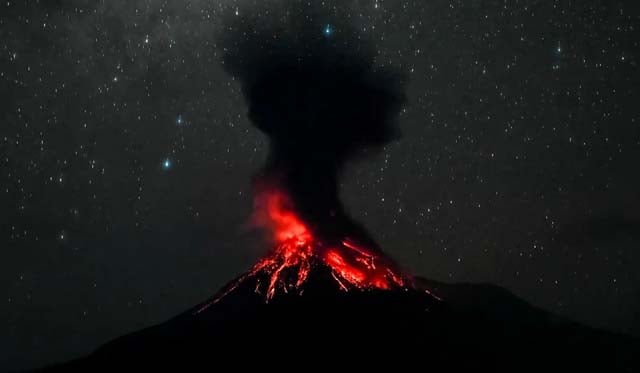 Indonesia volcano erupts, belching ash into night sky