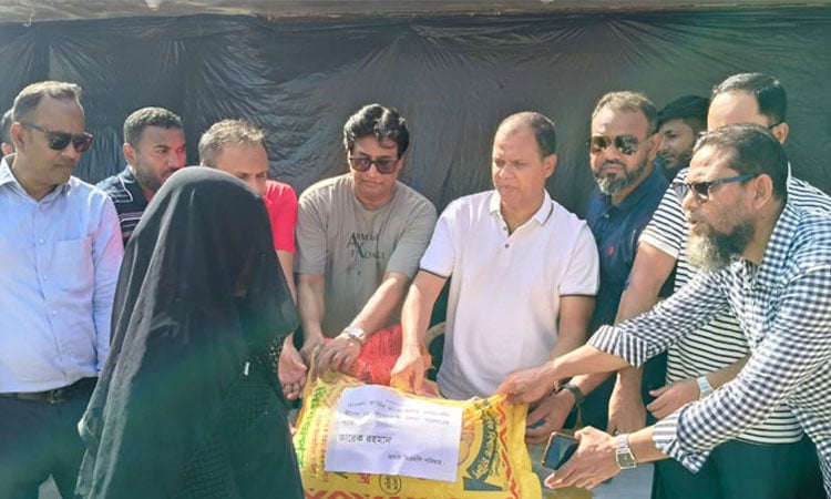 Tarique Rahman stands beside 18 fishermen families in Saint Martin