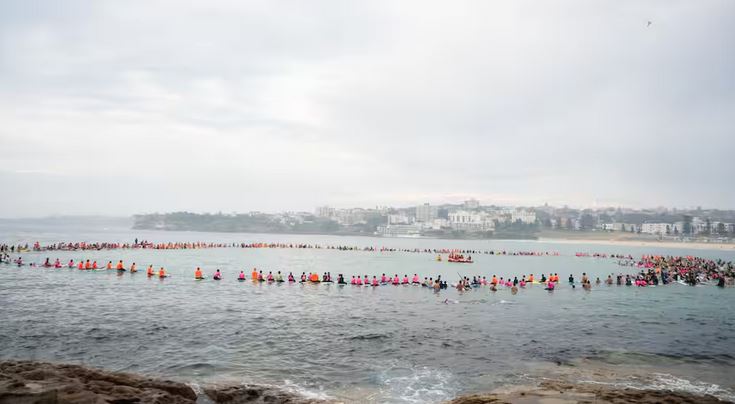 Hundreds paddle off Bondi Beach for boy killed by shark