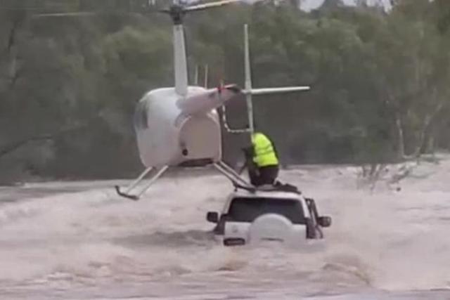 Helicopter rescue saves men, dog from Australian floodwaters