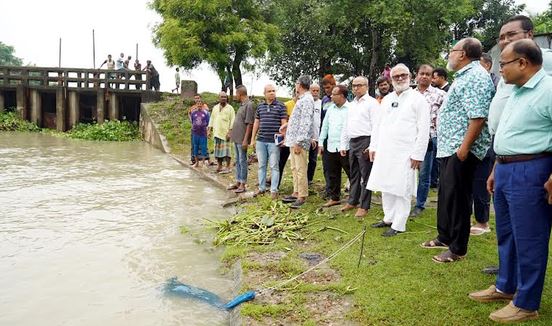 KCC administrator inspects sluice gate repair to prevent waterlogging