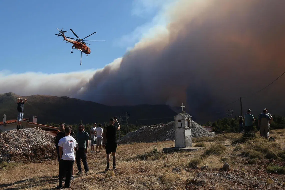 Greek mayor among three charged over wildfire near Athens